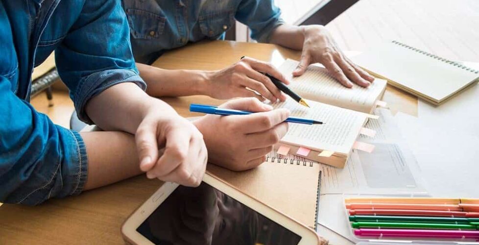 Two Asian students studying together at university.